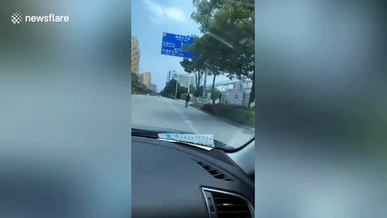 Chinese man spotted cycling with IV drip attached to him