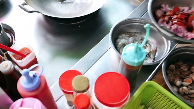 Cambodian roadside snacks - grilled frogs and fried cockles