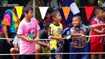 Bizarre race in Thailand where boys make a human boat and run through muddy field