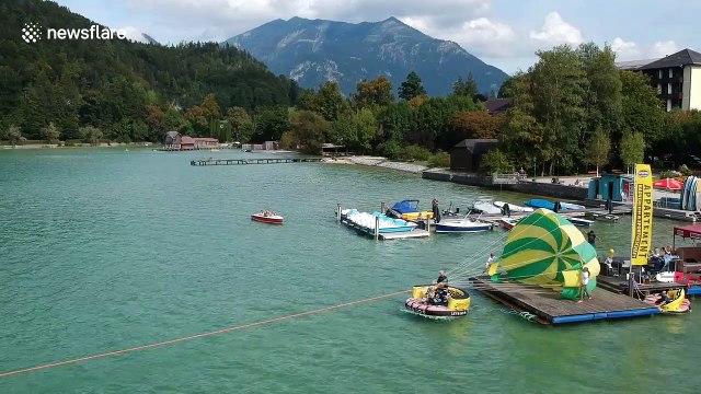 Scooter stuntman able to parasail his Vespa to world record over Austrian lake