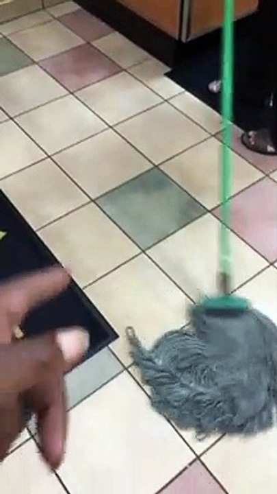 Fast Food Worker Uses Mop to Clean Benches