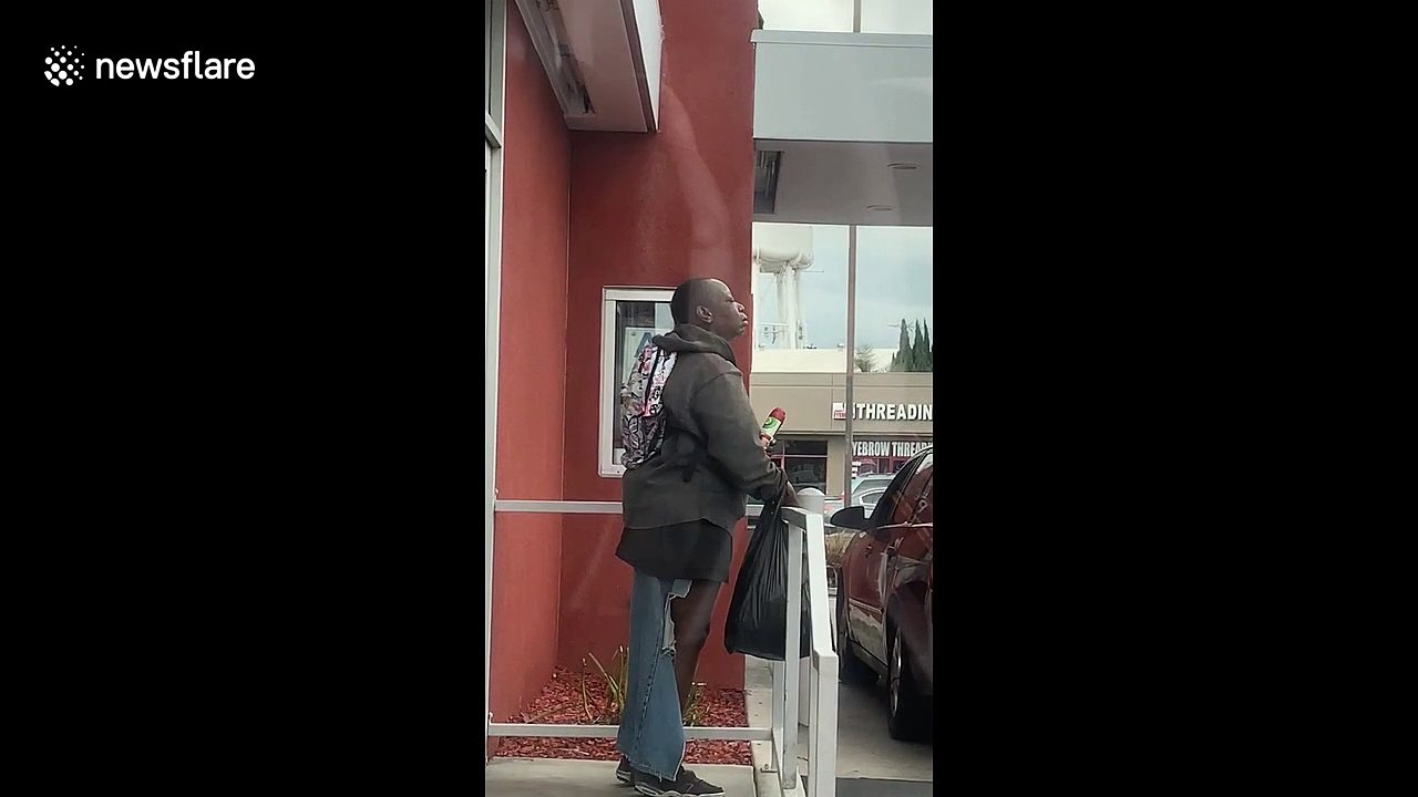A shocking moment a homeless woman sprays air refresher in her EAR