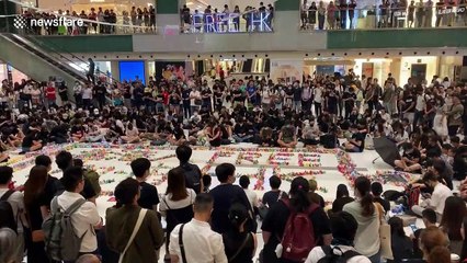 Kneeling Hong Kong protestors create huge origami mural in shopping mall