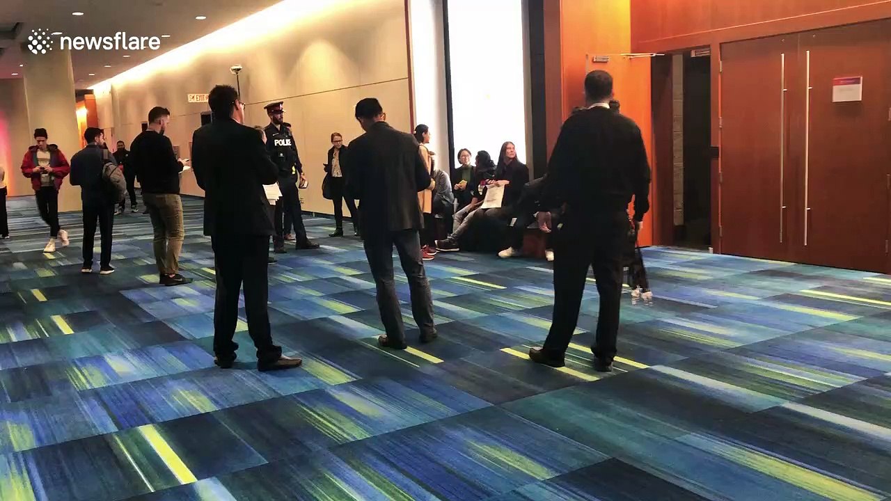 Pro-migrant protesters are quickly escorted from Amazon event in Toronto