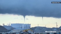 Multiple waterspouts start to spiral down