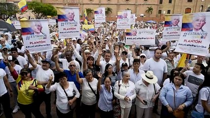 Hundreds march in defence of former Colombian President Uribe