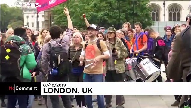 Extinction Rebellion activists glue hands to ground in central London