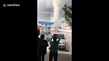 Terrified staff and customers run for cover as tornado rips through petrol station in Thailand