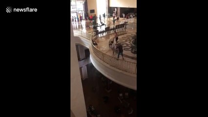 Employees attempt to clear floodwater at five-star hotel in Bodrum, Turkey