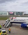 Man Sits on top of Plane at London City Airport