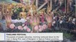Devotees shower golden Buddha barge with lotus flowers at Thai festival