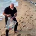 Narendra Modi use a plastic bag to pick up trash on a Tamil Nadu beach