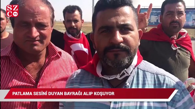 Patlama sesini duyan bayrağı alıp koşuyor