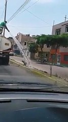 Water Truck Sprays Playful Pup