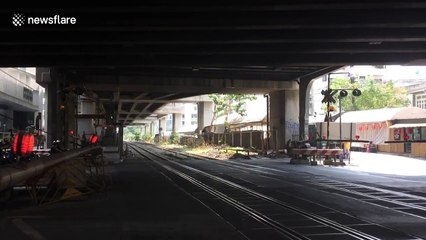 Impatient Thai motorcyclist clotheslined by level crossing barrier