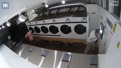 CCTV catches thieves smashing cash machine at a London launderette