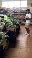 Cat Munches on Broccoli in Market Stall