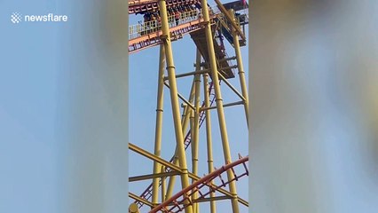 Chinese tourists hang UPISDE DOWN from roller coaster after power cut at amusement park