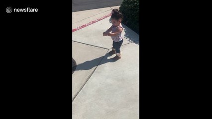 Curious toddler in California is afraid of her own shadow