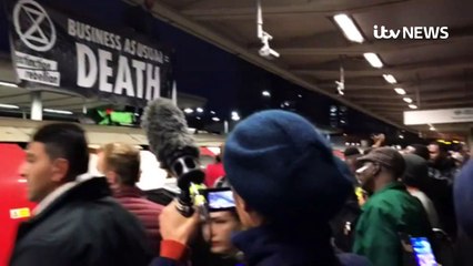 Commuters drag XR protester from top of Tube