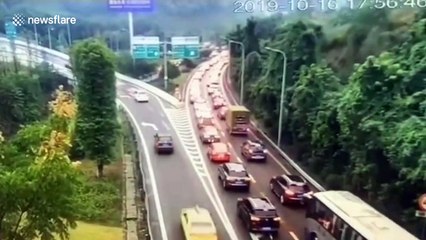 Vehicles narrowly avoid being buried by mud and trees after landslide in Chongqing