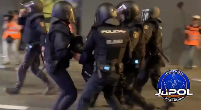 Agentes auxilian a un policía en los altercados en Cataluña