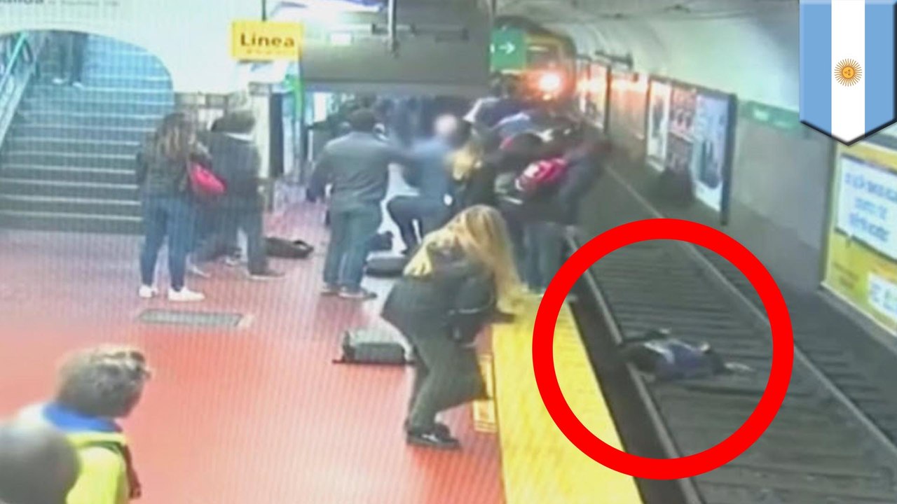 Passengers stop subway train from hitting woman on tracks