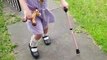 Brave Dottie walks with a single walking stick for the first time.
