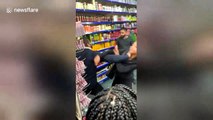 Shocking moment suspected shoplifters fight with shopkeepers in London