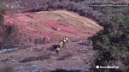 Firefighters and helicopter battle wildfire near military base