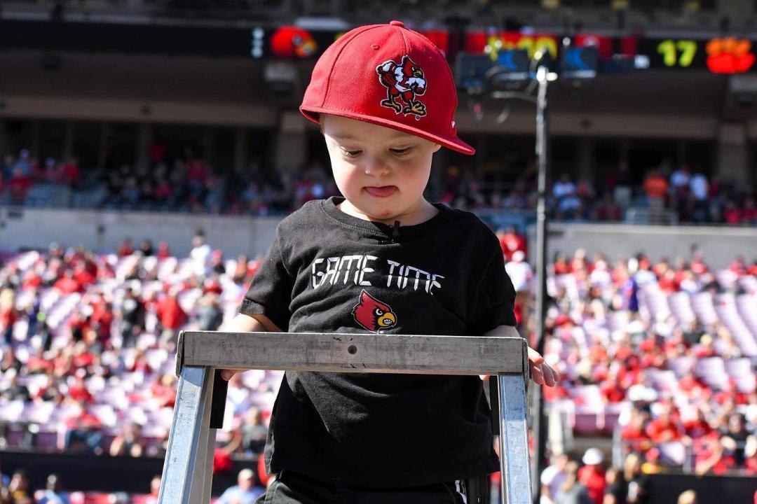 4-Year-Old with Down Syndrome Becomes the “Cutest Director Ever” for Louisville Marching Band