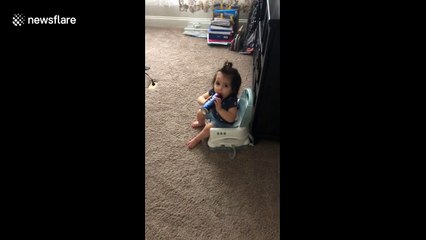 Sneaky baby gets caught trying to drink from beer can