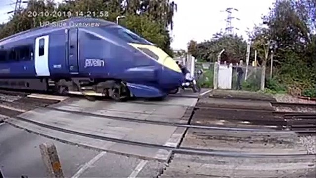 Shocking footage shows biker trying to skip through level crossing – as speeding train was approaching