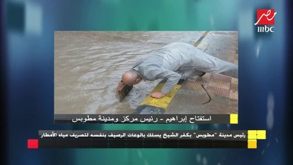 رئيس مدينة "مطوبس" بكفر الشيخ يسلك بالوعات الرصيف بنفسه لتصريف مياه الأمطار