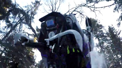 Snowmobile Rolls Back on Rider