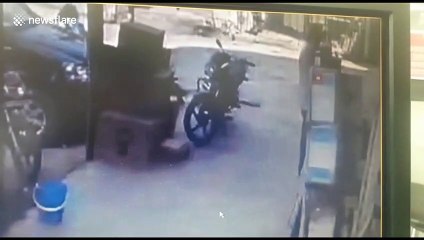 Two men fall into huge hole when pavement collapses in northern India