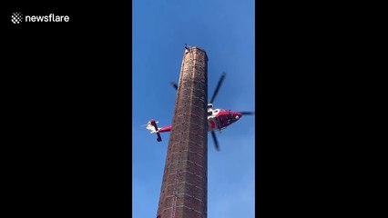 Man hanging upside down from 290ft chimney in England confirmed dead