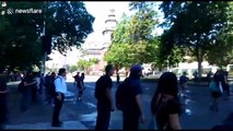 Chilean protestors throwing objects against police truck
