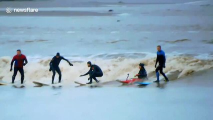 Surfers ride UK's spectacular natural phenomenon Severn Bore