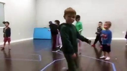 Kids Run Around And One Kid Falls When Colliding Into An Adult