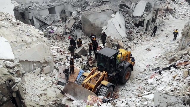 Syria rescue workers look for survivors after an air strike in Idlib