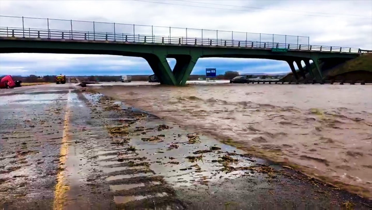 Flood waters scour roadway