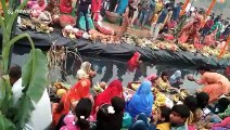 Hundreds of devotees line up in neck-deep water for Hindu festival