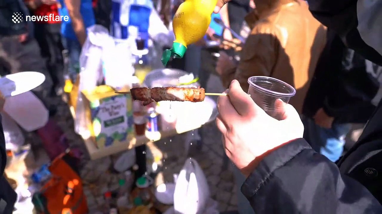 Greek nationalists hold pork barbecue close to refugee camp