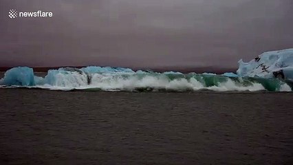 Large chunk of melting glacier in Iceland seen sliding into sea