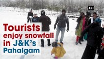 Tourists enjoy snowfall in Jammu and Kashmir’s Pahalgam