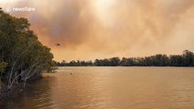 Skycrane helicopter fighting Australia bushfires refills water on the Manning River