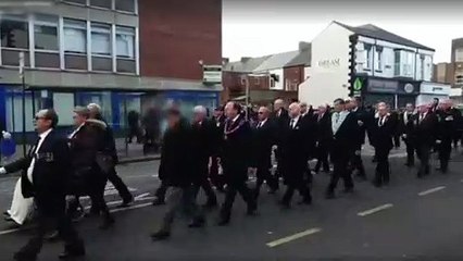 A cyclist rides through the Remembrance parade in Hartlepool