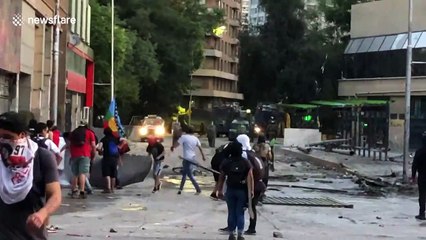 Anti-government demonstrators shine laser pointers at police during clashes in Santiago, Chile
