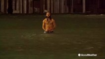 Man swims through flooded famous tourist spot in Venice